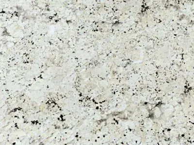 Close-up of a natural stone granite surface with a speckled pattern of black, white, and gray colors.