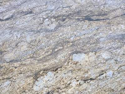 Close-up of natural stone countertop surface with layered patterns and speckled details.