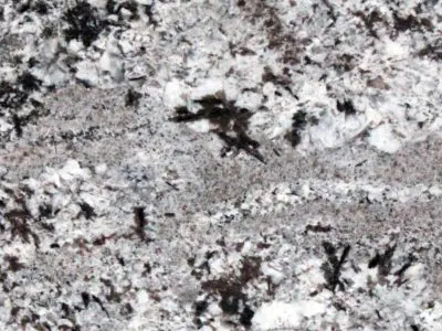 Close-up of a natural stone granite surface showing a speckled pattern with shades of gray, black, and white.