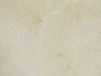 Close-up of a natural stone beige marble countertop with subtle veins and speckles.