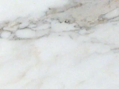 Close-up of a white marble surface with subtle gray veins, ideal for natural stone countertop installation.