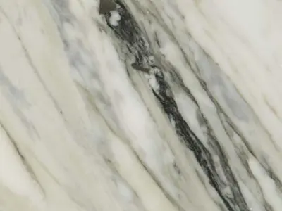 Close-up of a natural stone countertop with grey veining on a white background.