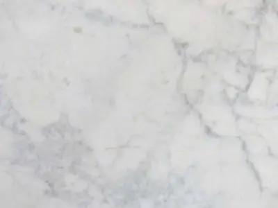 Close-up of a natural stone surface with subtle gray veining.