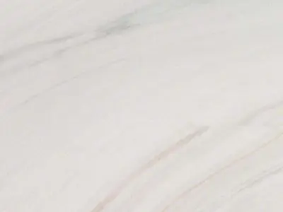 Close-up view of a natural stone countertop with subtle white and pink veins.