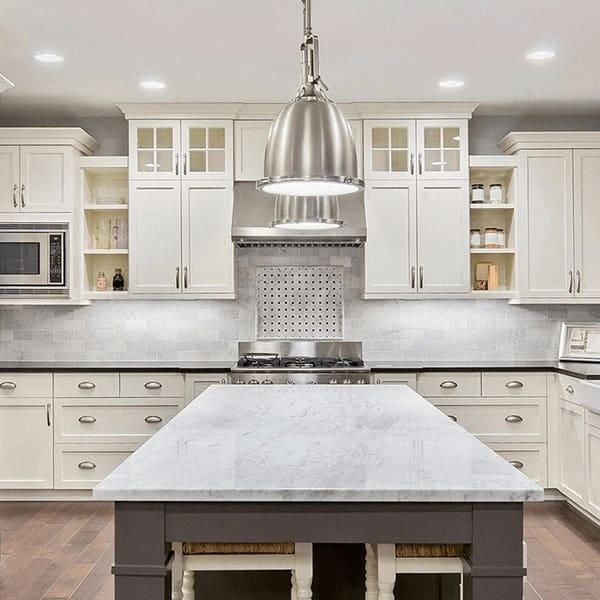 Modern kitchen with white cabinets and marble countertops