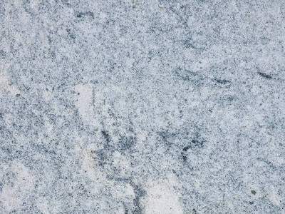 Close-up texture of a natural stone surface with speckled patterns.