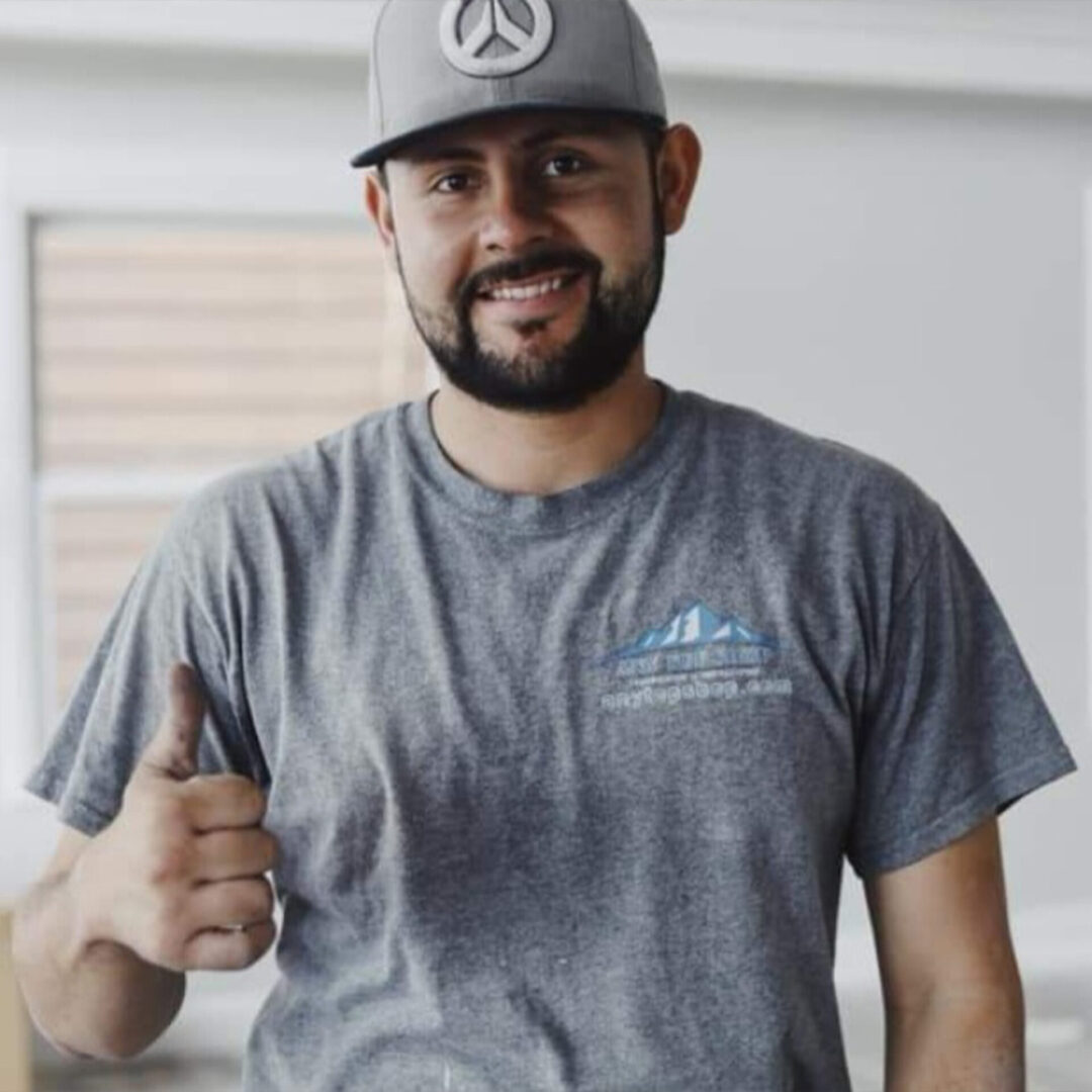 Victor, lead countertop installer at Any Top Shop, smiling and giving a thumbs-up during a residential installation project.