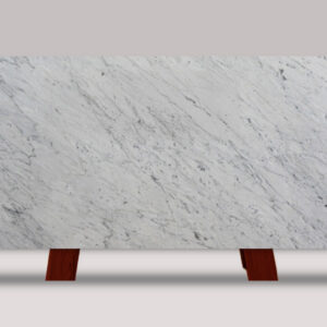 Full slab of Calacatta Carrara marble featuring a white background with soft gray veining and subtle natural stone movement.