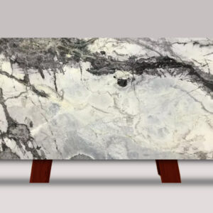 Full slab of Iceberg Marble featuring a white background with dramatic black and gray veining and bold natural stone movement.