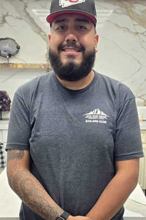 Brandon, templator at Any Top Shop, standing in front of a natural stone slab in the countertop showroom