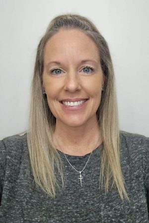 Cheri Blessing, Operations Manager at Any Top Shop, smiling in a professional office portrait