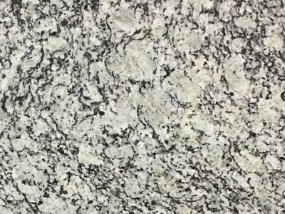 Close-up of white and black speckled granite surface.