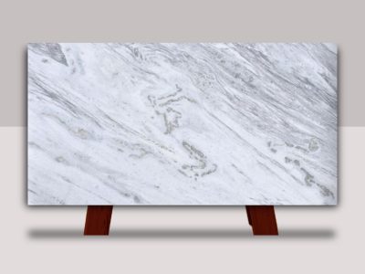 Full slab of Shadow Storm marble featuring a soft white background with flowing gray veining, displayed for custom marble countertop fabrication and installation.