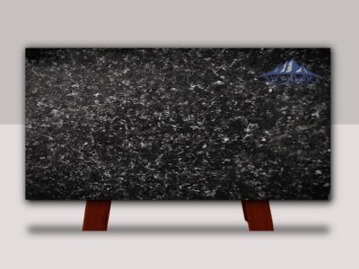 A polished black granite slab with a speckled pattern on a stand.