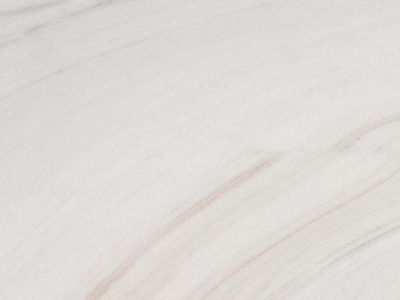 Close-up of Calacatta Lasa marble featuring a white background with soft gray veining and natural stone variation.