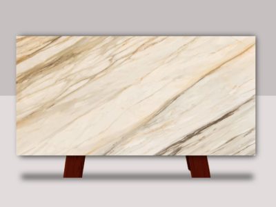 Full slab of Calacatta Gold marble featuring a white background with flowing gray and warm gold veining throughout the natural stone surface.