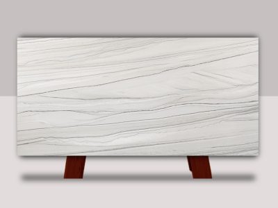 Chantilly Quartzite slab featuring sweeping horizontal bands of gray, charcoal, and ivory veining across a soft white background.