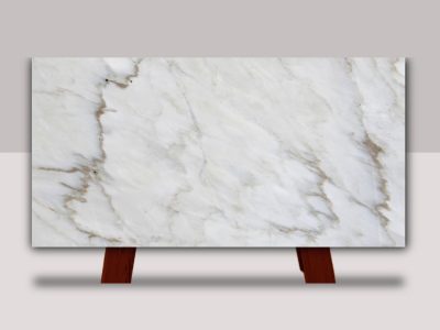 Full slab of Crema Delicato marble featuring a soft white and cream background with subtle gray veining and warm natural stone accents.