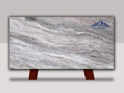 A polished slab of marble with gray and white swirling patterns.
