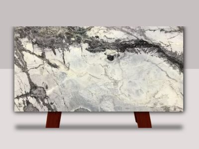 Full slab of Iceberg Marble featuring a white background with dramatic black and gray veining and bold natural stone movement.