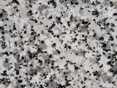 Close-up of speckled granite surface with black and white patterns.