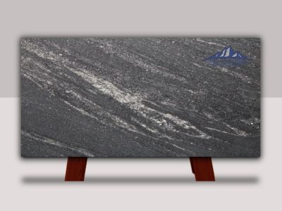 Polished dark gray marble slab with white veining on red supports.