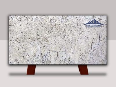 Polished white marble slab with subtle gray veining on a wooden stand.