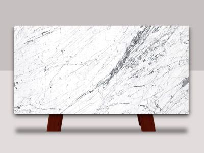 Full slab of Statuarietto marble featuring a bright white background with dramatic gray veining and natural stone movement.