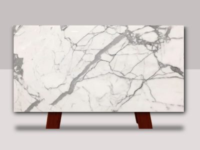 Full slab of Statuario Venato marble featuring a bright white background with flowing gray veining and natural stone movement.