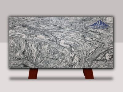 A polished slab of intricately patterned granite with grey, white, and black swirls.