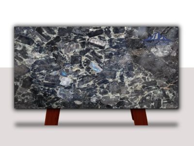 Polished dark marble slab with intricate white and blue veining, displayed on wooden supports.